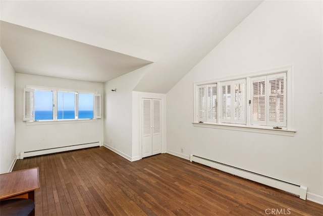 bonus room featuring a baseboard heating unit, vaulted ceiling, and dark hardwood / wood-style flooring