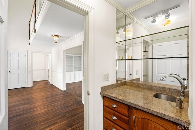 bathroom featuring ornamental molding, vanity, rail lighting, and hardwood / wood-style floors