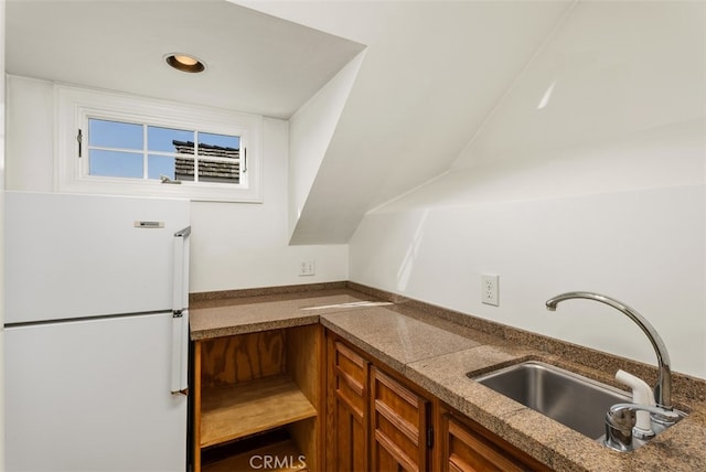 kitchen featuring white refrigerator and sink