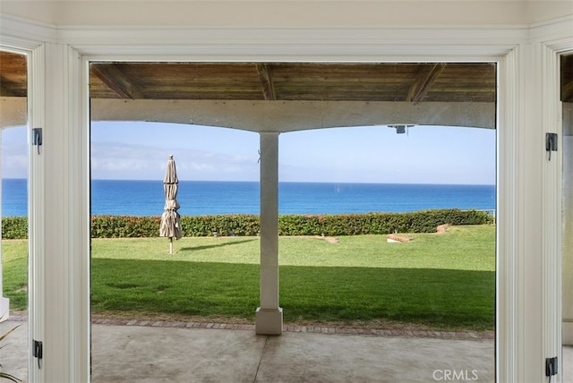 view of yard featuring a patio area and a water view