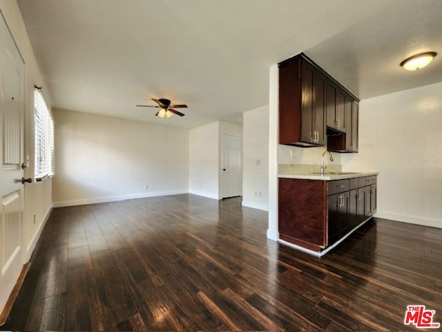 kitchen featuring dark brown cabinetry, ceiling fan, dark wood-type flooring, and sink