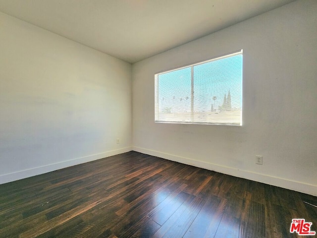 spare room featuring dark hardwood / wood-style floors