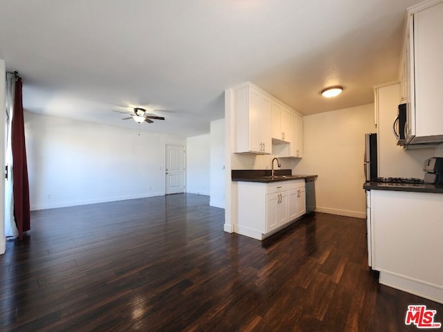 kitchen featuring ceiling fan, sink, white cabinetry, appliances with stainless steel finishes, and dark hardwood / wood-style floors