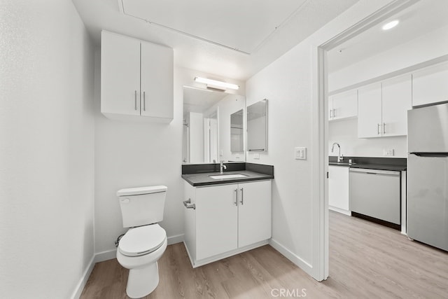 bathroom featuring hardwood / wood-style flooring, vanity, and toilet