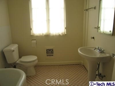 bathroom with toilet and plenty of natural light