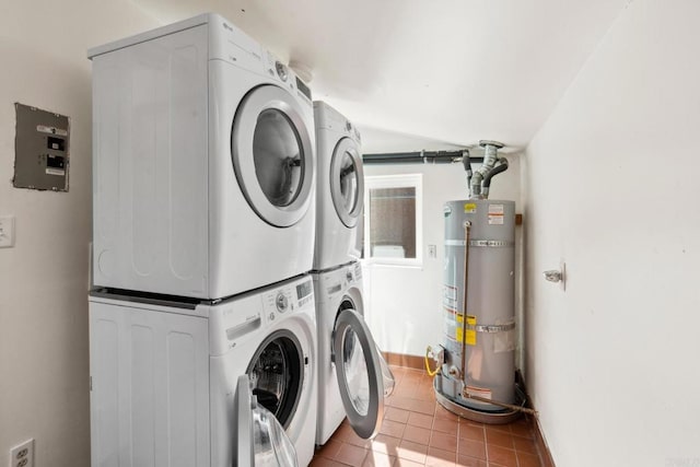 washroom featuring stacked washer and clothes dryer, strapped water heater, and light tile floors