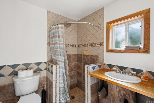 bathroom featuring toilet, walk in shower, vanity, and tile walls