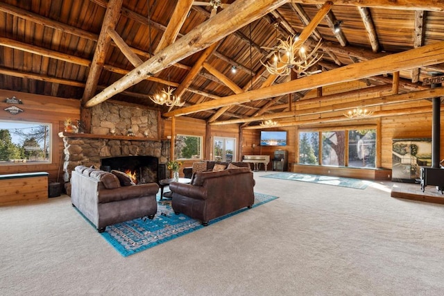 carpeted living room featuring a notable chandelier, a fireplace, wood ceiling, and a healthy amount of sunlight