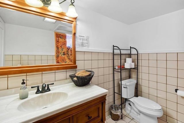 bathroom with toilet, vanity with extensive cabinet space, backsplash, tile walls, and tile floors