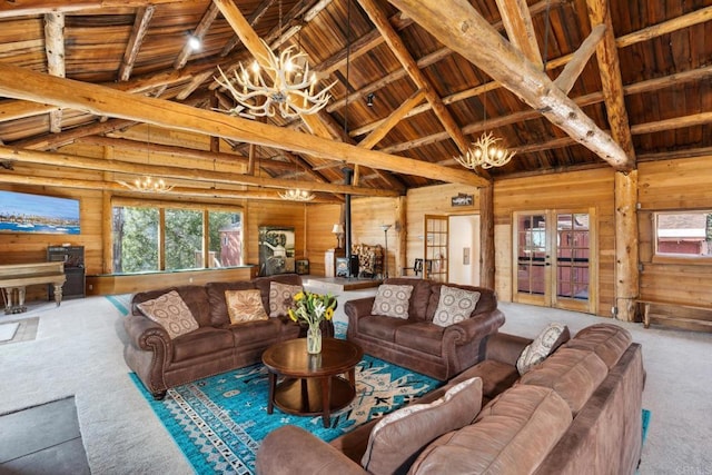 carpeted living room with wooden ceiling, an inviting chandelier, wooden walls, high vaulted ceiling, and beam ceiling