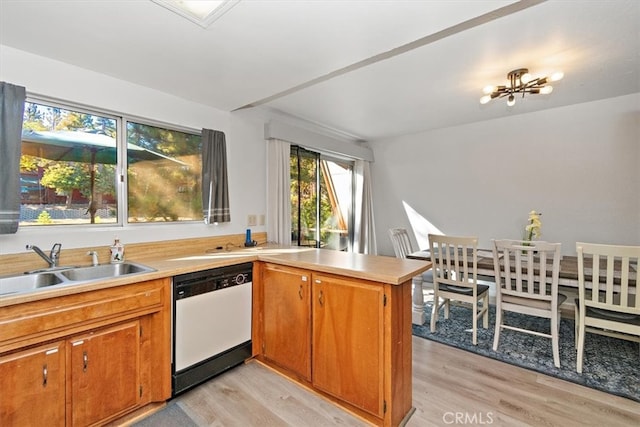 kitchen featuring dishwasher, kitchen peninsula, light hardwood / wood-style floors, and sink