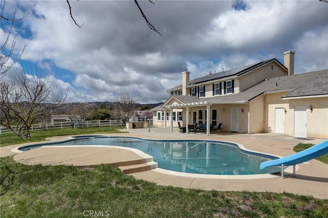 view of pool featuring a patio and a water slide