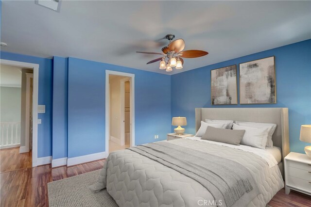 bedroom featuring ceiling fan and dark wood-type flooring