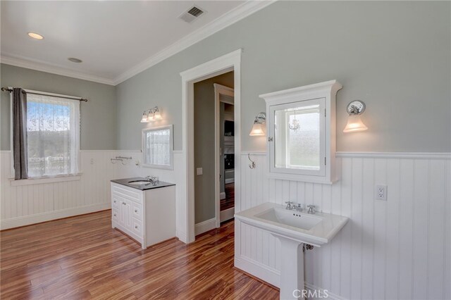 bathroom with wood-type flooring and crown molding