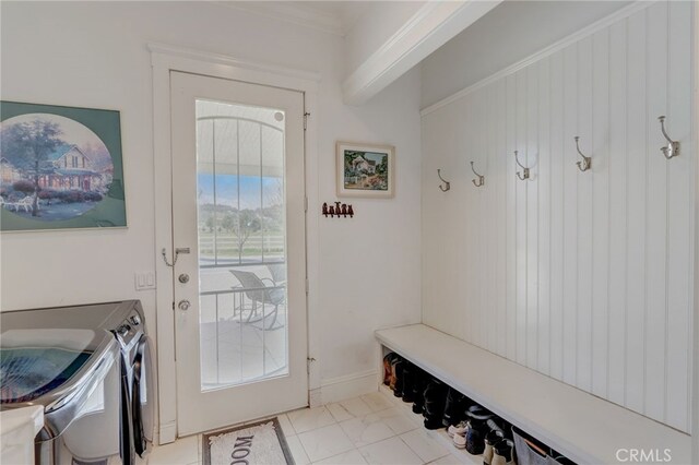 mudroom featuring washer and dryer, light tile patterned floors, and crown molding