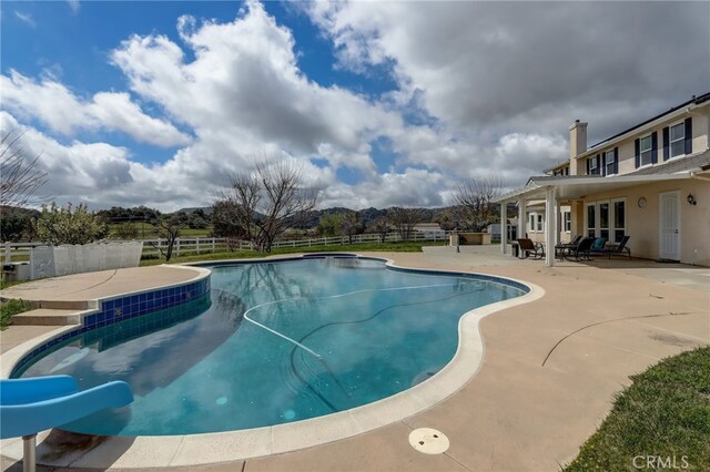 view of pool featuring a patio area and a water slide