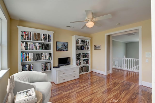 living area with ceiling fan and wood-type flooring