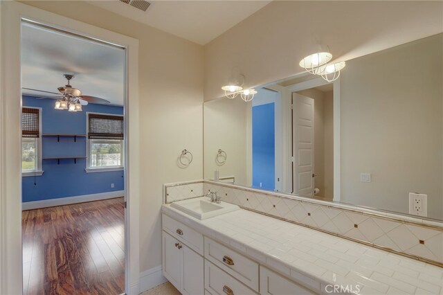 bathroom with hardwood / wood-style flooring, ceiling fan, toilet, and vanity