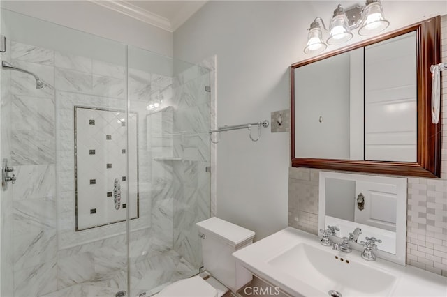 bathroom with crown molding, sink, a shower with door, and toilet