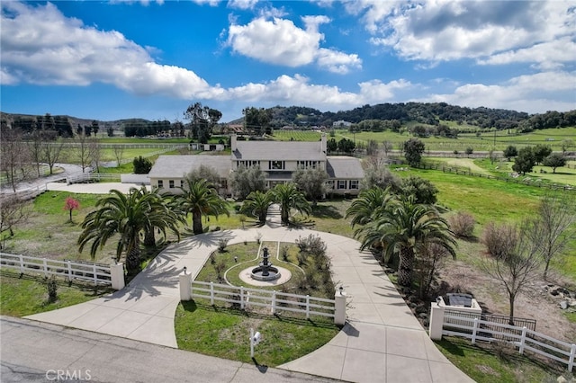 view of home's community with a mountain view and a rural view