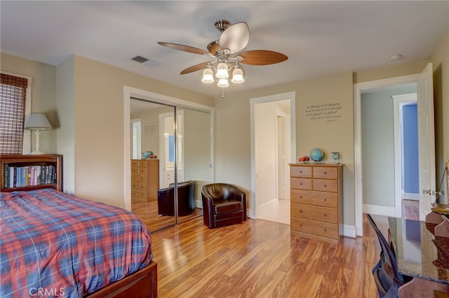 bedroom featuring ceiling fan, a closet, and light hardwood / wood-style floors