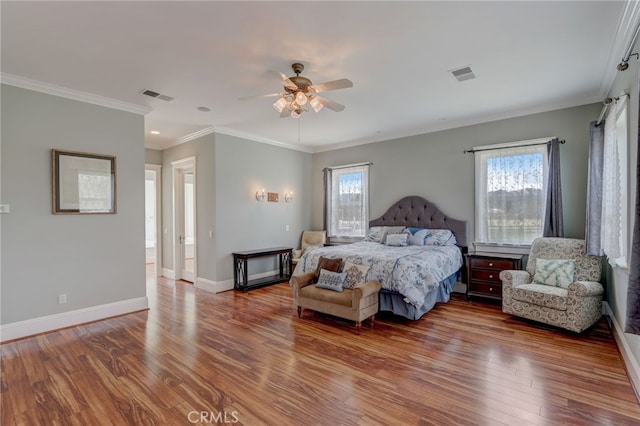 bedroom with multiple windows, wood-type flooring, ceiling fan, and crown molding