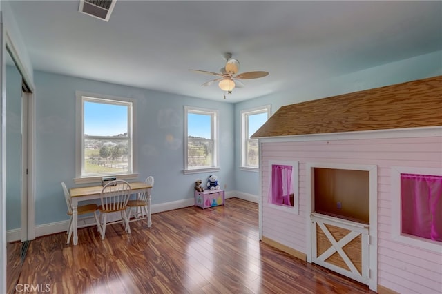 interior space with ceiling fan and wood-type flooring