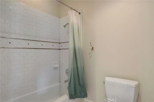 bathroom with toilet and shower / tub combo with curtain