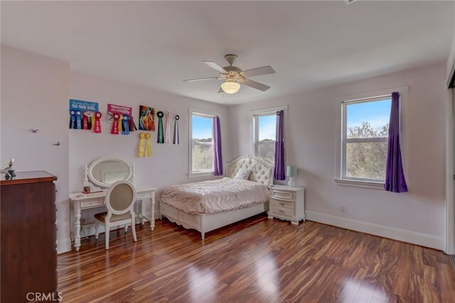 bedroom with ceiling fan and dark wood-type flooring