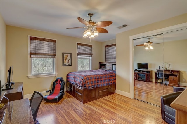 bedroom featuring ceiling fan, a closet, and light hardwood / wood-style floors