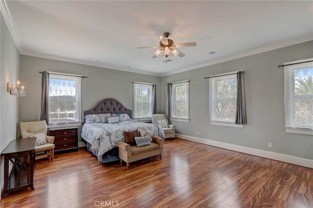 bedroom featuring multiple windows, ceiling fan, and hardwood / wood-style flooring