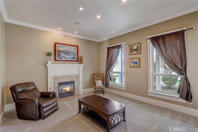 carpeted living room with a fireplace, a wealth of natural light, and ornamental molding