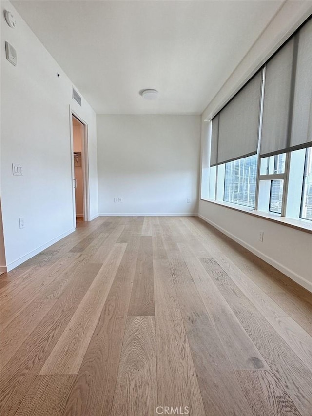 spare room featuring light hardwood / wood-style floors