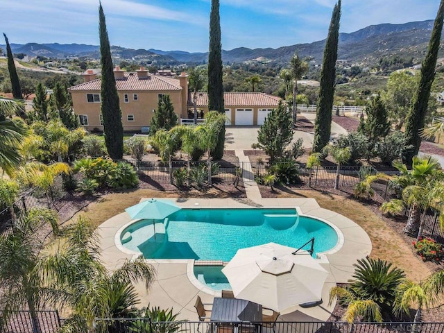 view of pool featuring a mountain view and a patio area