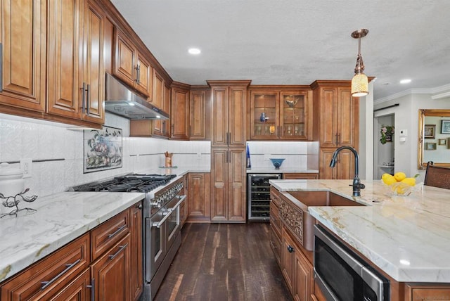 kitchen with dark hardwood / wood-style flooring, beverage cooler, hanging light fixtures, stainless steel appliances, and crown molding