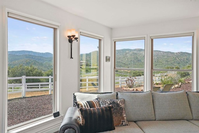 sunroom with a mountain view and plenty of natural light