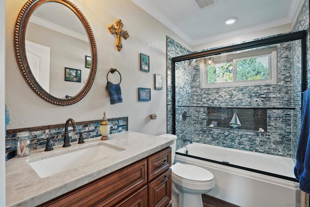 full bathroom with ornamental molding, combined bath / shower with glass door, vanity, and toilet