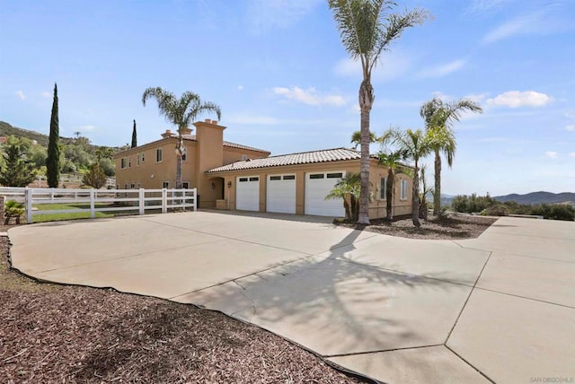 view of home's exterior with a garage and a mountain view