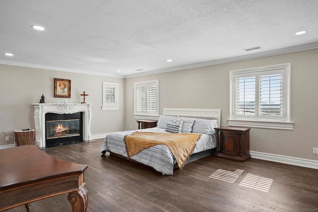 bedroom with a textured ceiling, dark hardwood / wood-style floors, and ornamental molding