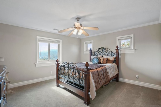 carpeted bedroom with ceiling fan, ornamental molding, and multiple windows