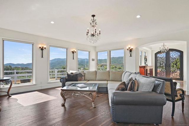 living room with dark wood-type flooring, a mountain view, and french doors