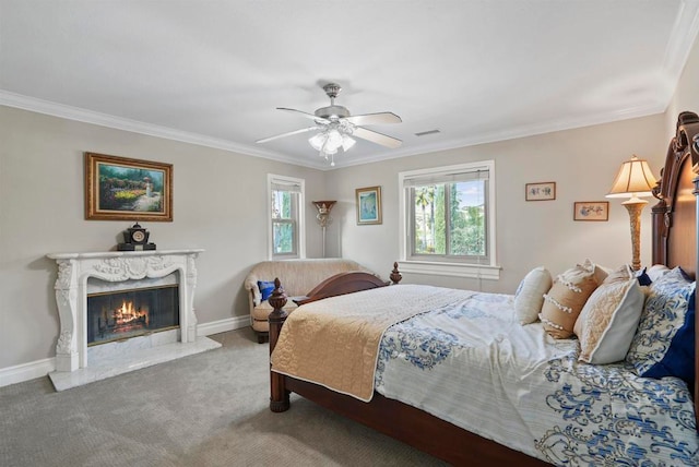 bedroom with ceiling fan, carpet flooring, a fireplace, and ornamental molding