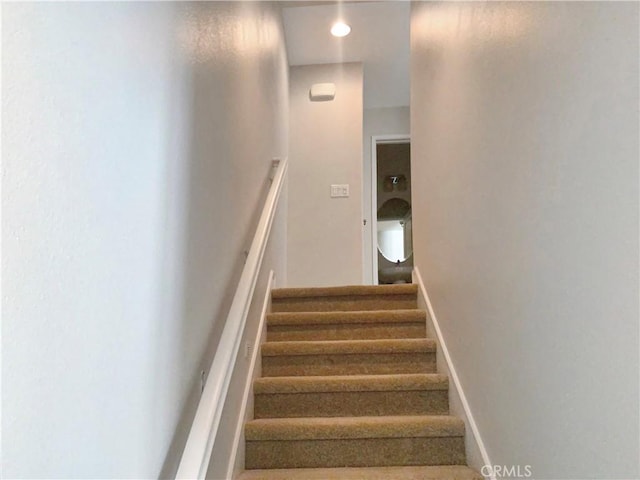 stairway featuring baseboards