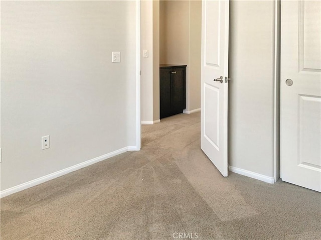 hall with carpet flooring and baseboards