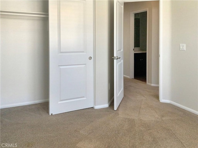 unfurnished bedroom featuring baseboards and carpet flooring