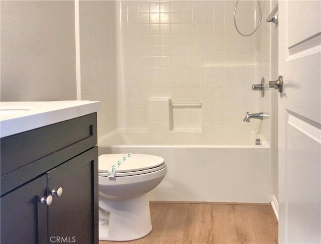 full bathroom featuring vanity, shower / washtub combination, wood finished floors, and toilet