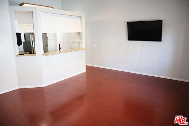 unfurnished living room with dark hardwood / wood-style floors