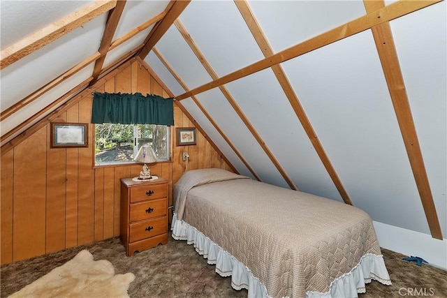 bedroom with lofted ceiling with beams and wooden walls