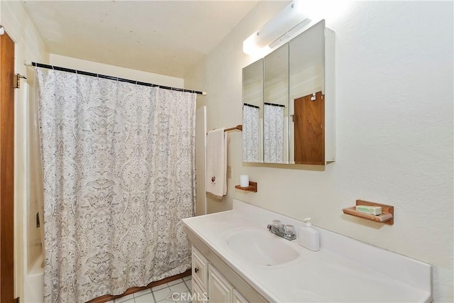 bathroom with tile patterned flooring, shower / tub combo, and vanity