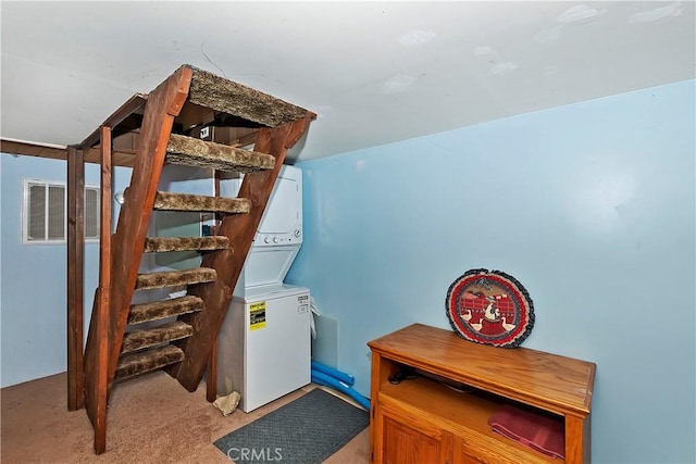 basement with stacked washer / dryer and light colored carpet